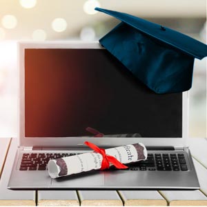 laptop, graduation cap and degree
